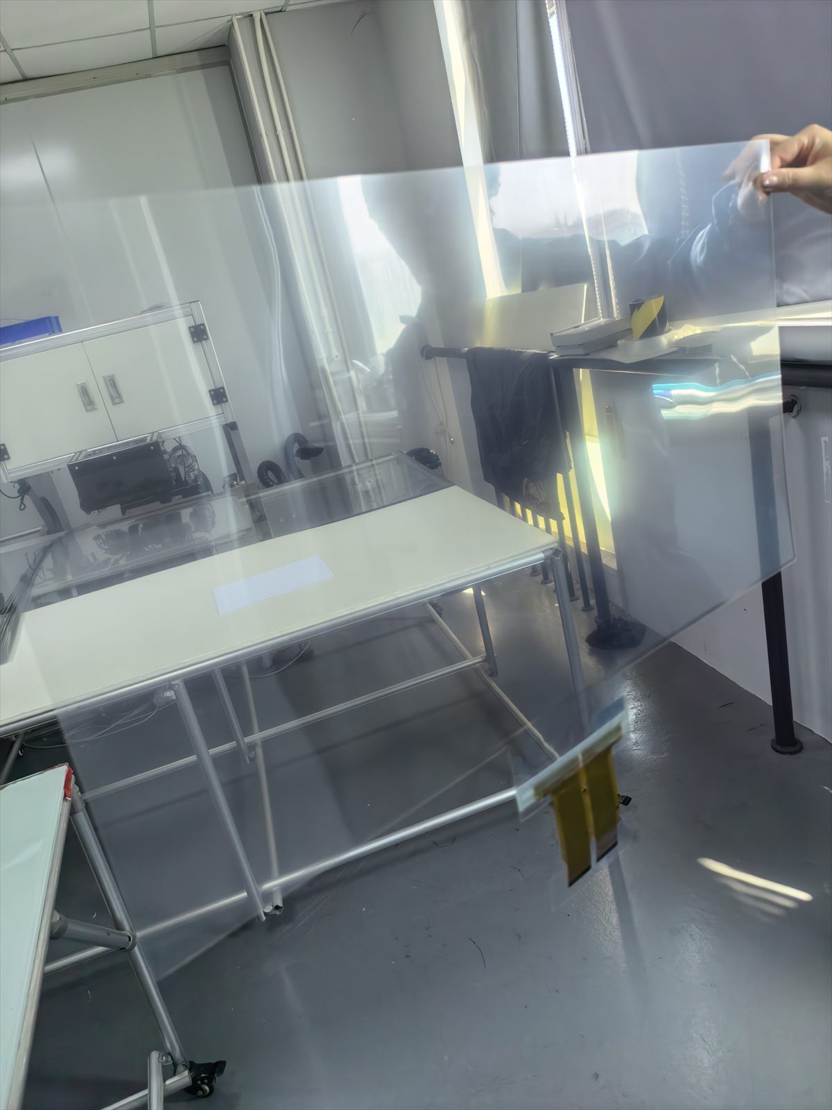 DRWO finished large-format transparent capacitive touch film held for optical inspection