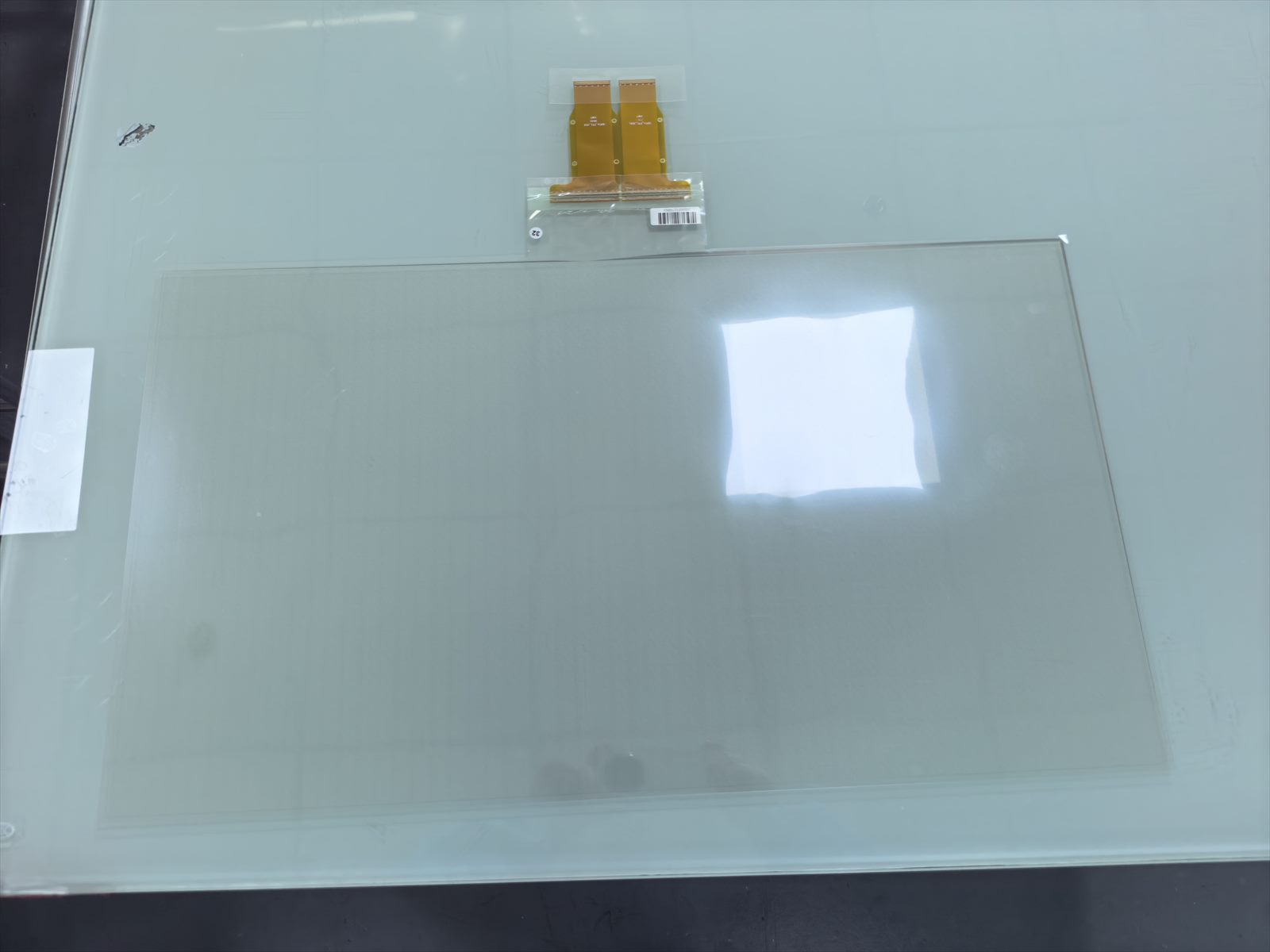 DRWO Metal Mesh touch-film sample showing the transparent active area and paired FPC electrode tails